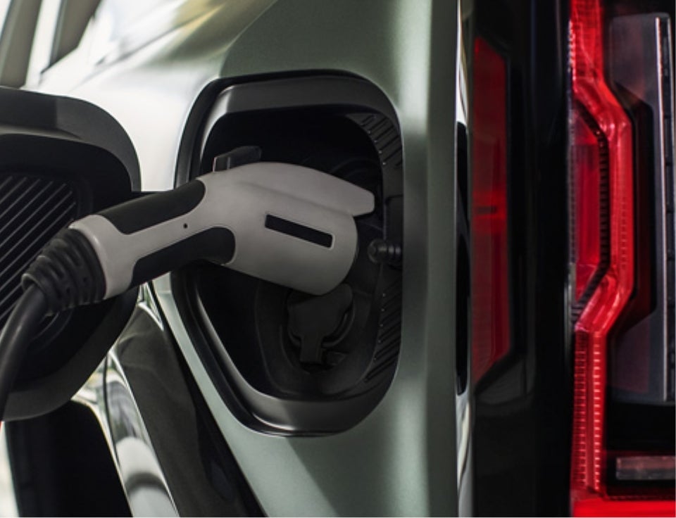 Close up of charging port with charger plugged in on a GMC Hummer EV SUV - McConnell GMC in MOBILE AL