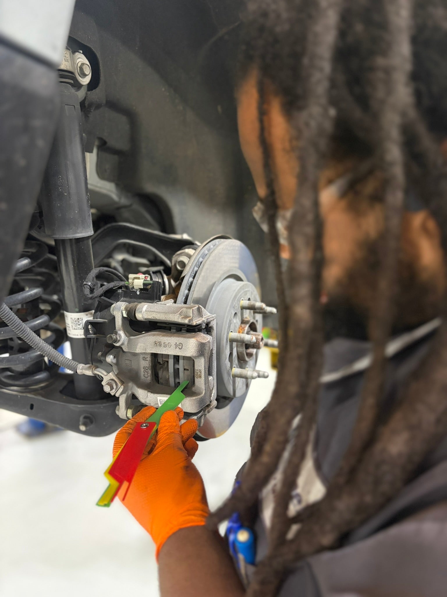 McConnell Automotive DJ inspecting vehicle brakes in Mobile AL